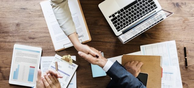 business-people-shaking-hands-together (1)