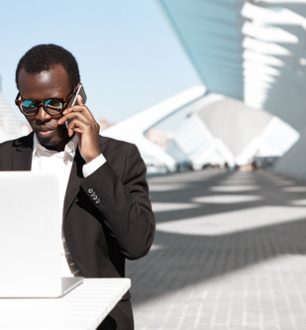 outdoor-portrait-successful-confident-young-african-entrepreneur-corporate-worker-black-suit-stylish-shades-having-phone-conversation-working-remotely-laptop-pc-urban-cafe (1) outdoor-portrait-successful-confident-young-african-entrepreneur-corporate-worker-black-suit-stylish-shades-having-phone-conversation-working-remotely-laptop-pc-urban-cafe (1)
